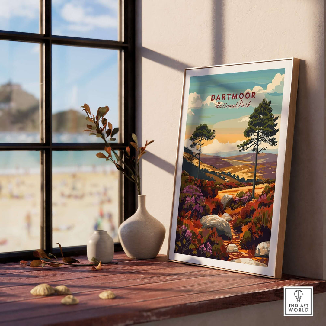 Dartmoor National Park wall art displayed on a wooden table near a window, showcasing vibrant landscapes and greenery.