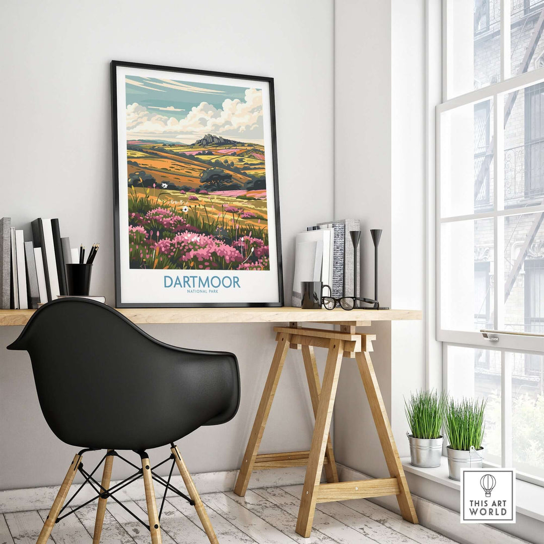 Dartmoor travel print displayed on a stylish desk in a bright room, showcasing beautiful rolling hills and vibrant flowers.