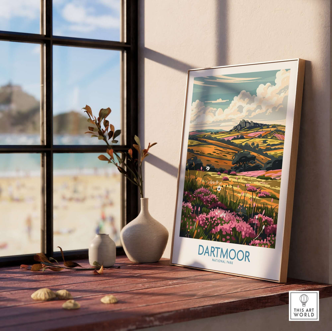 Dartmoor travel print displayed by a window, showcasing vibrant landscapes and colorful flowers, capturing nature's beauty.