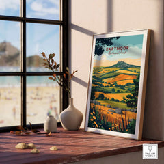 Dartmoor Wall Art Print displayed on a wooden table with a scenic view of Dartmoor National Park in the background.