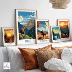 Framed national park posters with landscape and wildlife art on a modern living room wall.