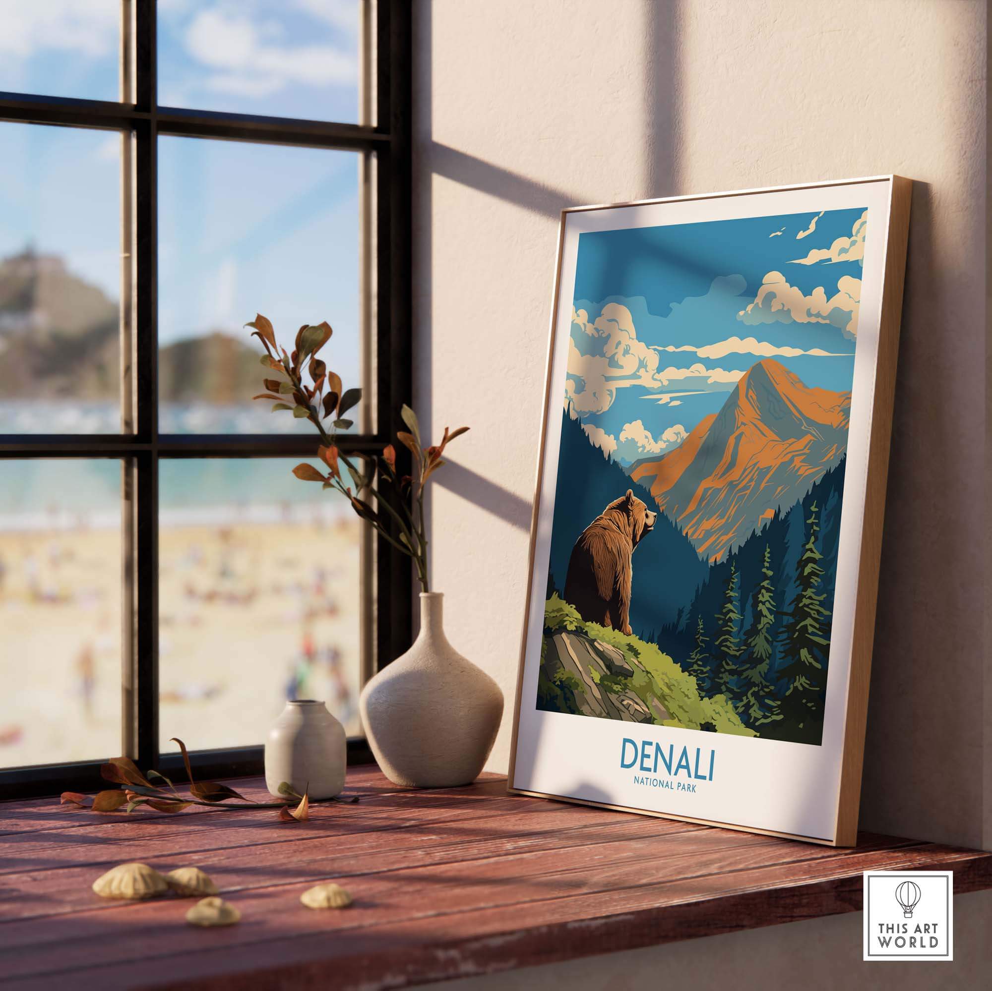 Denali National Park poster with bear, mountains, and pine trees on a wooden windowsill