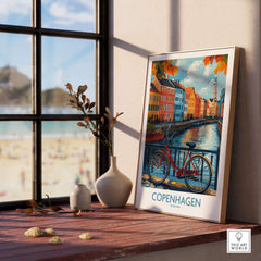 Denmark Copenhagen Fall Poster - Red Bicycle, Colorful Canal Houses Art displayed in a cozy room by a window.