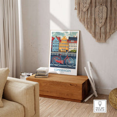 Denmark Copenhagen Poster - Red Bike, Colorful Canal Houses Art displayed in a cozy living space with wood decor.