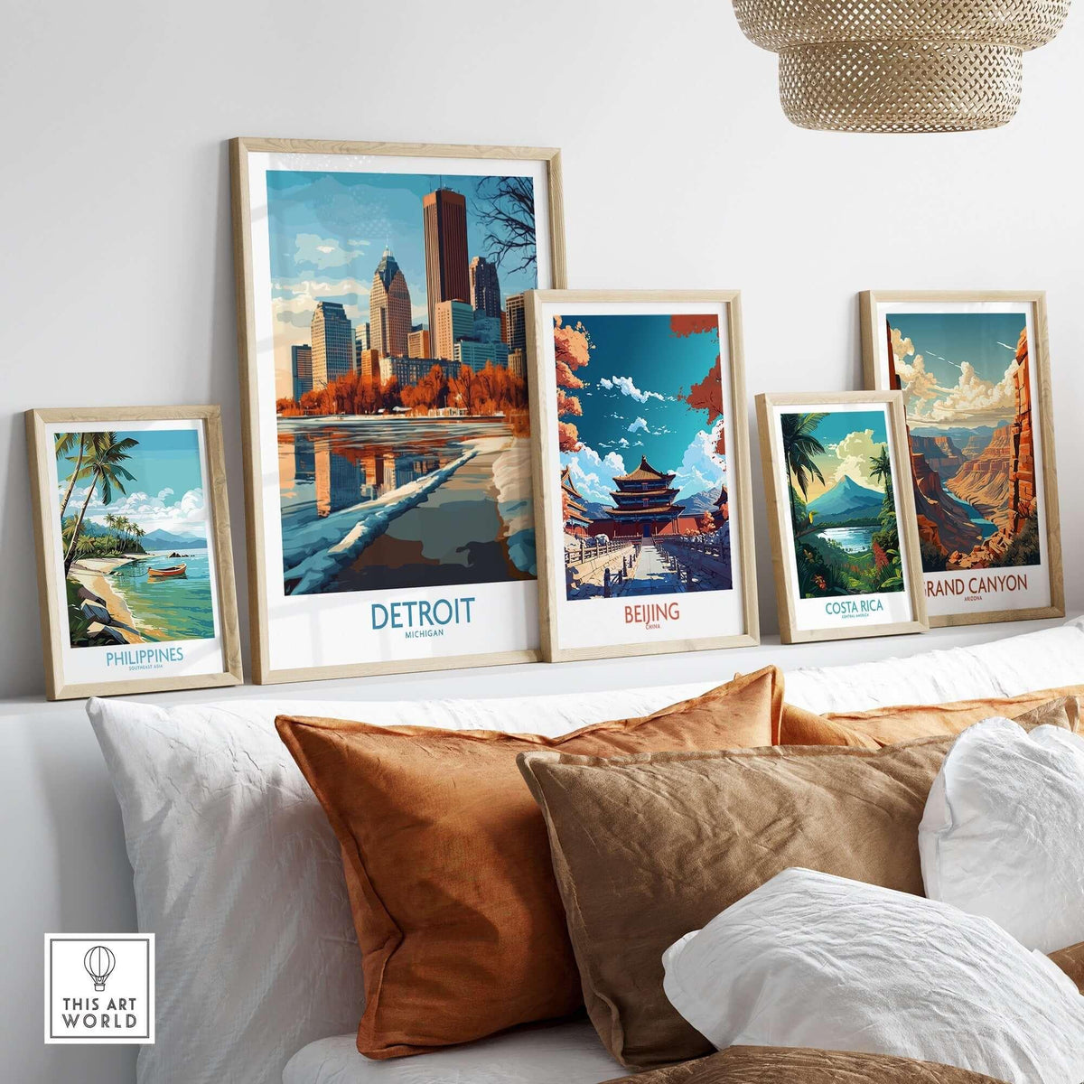 Detroit Poster Michigan displayed with other travel posters on a cozy couch, showcasing iconic landmarks.