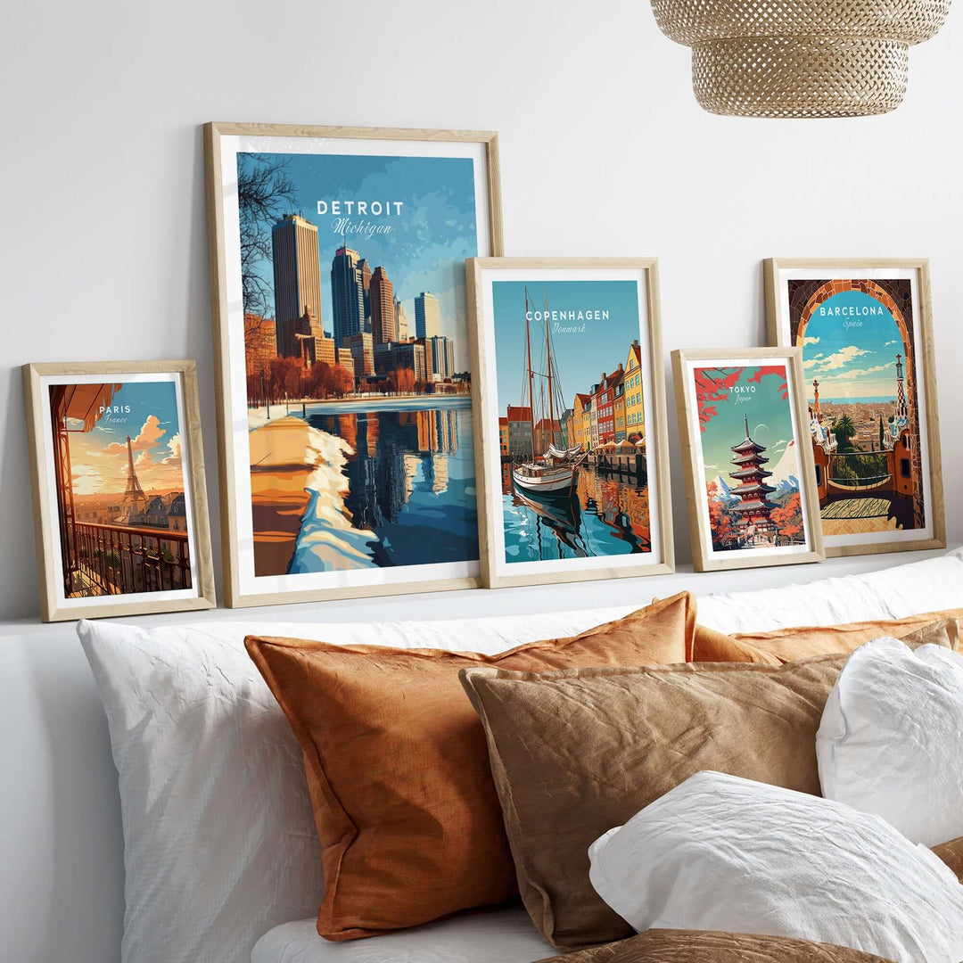 Vibrant collection of city posters, including Detroit, displayed in stylish frames above a cozy sofa.