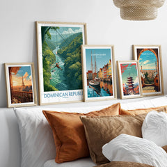 Travel posters of Paris, Dominican Republic, Copenhagen, Tokyo, and Barcelona in wooden frames above a bed