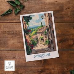 Dordogne Travel Poster featuring a picturesque street in Dordogne, France with lush greenery and charming architecture.