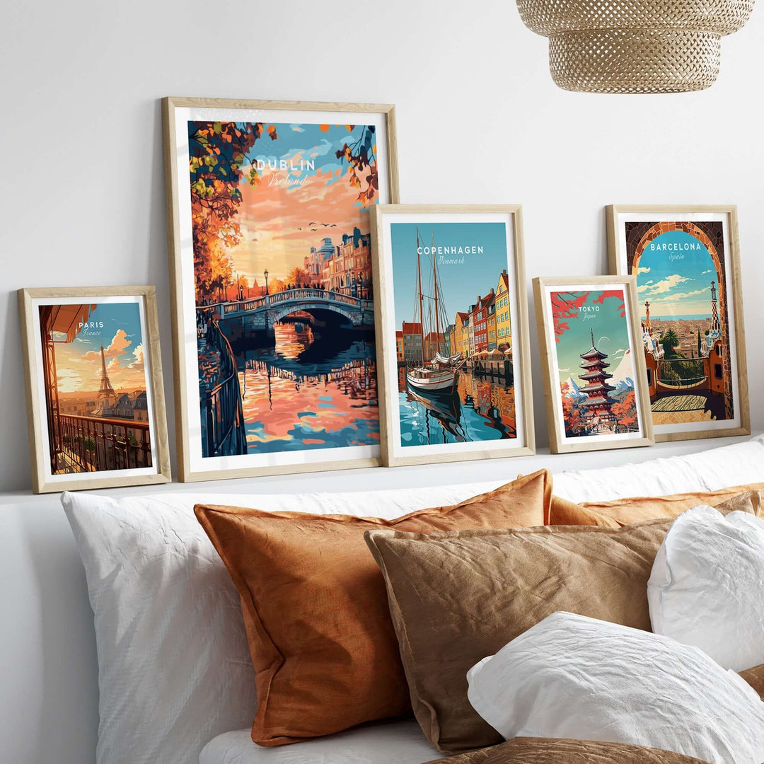 Collection of vibrant city art prints including Dublin, Copenhagen, and Barcelona displayed above a cozy sofa.