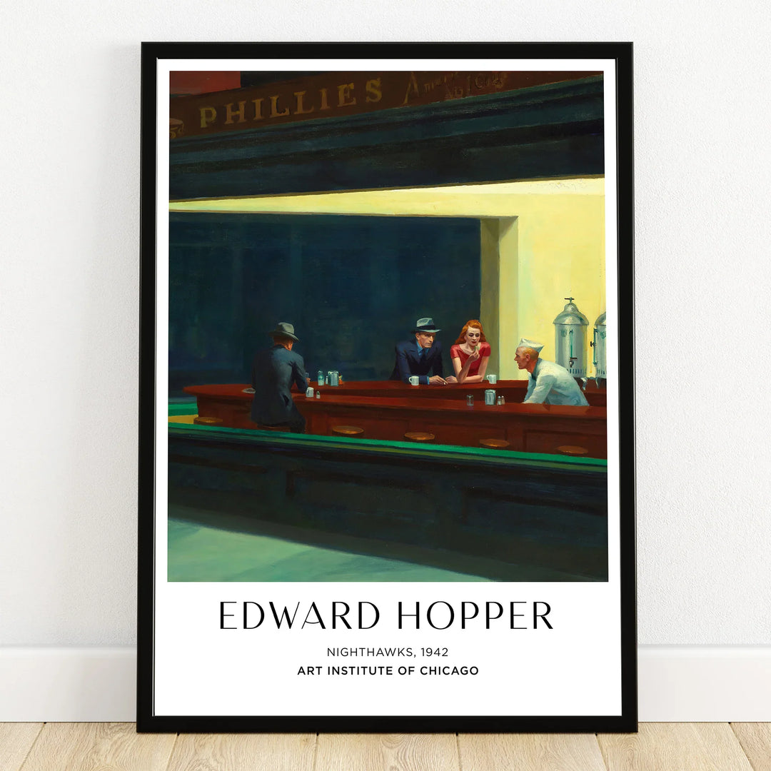 Framed Edward Hopper Nighthawks print featuring a city diner at night with figures at the counter
