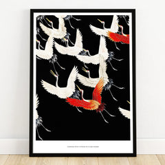 Framed wall art print of flying white and red cranes on a black background, modern decor