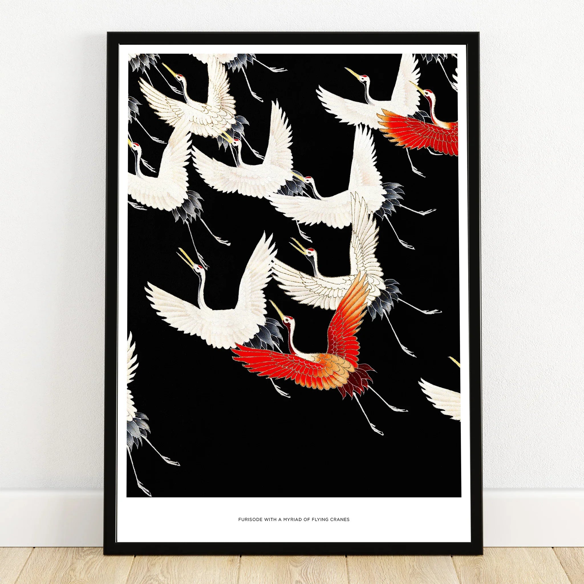 Framed wall art print of flying white and red cranes on a black background, modern decor