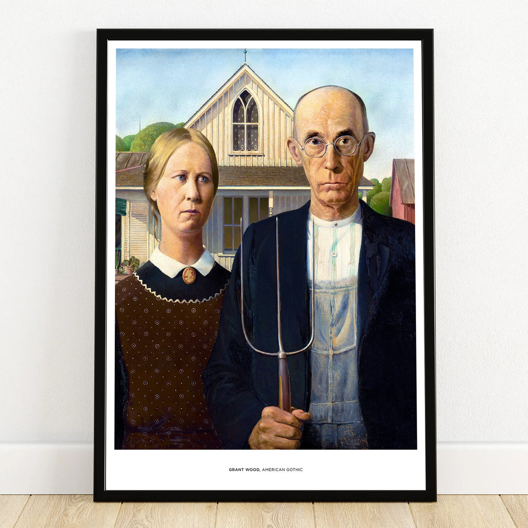 Framed art print of a classic American Gothic painting with farmer and woman in front of house
