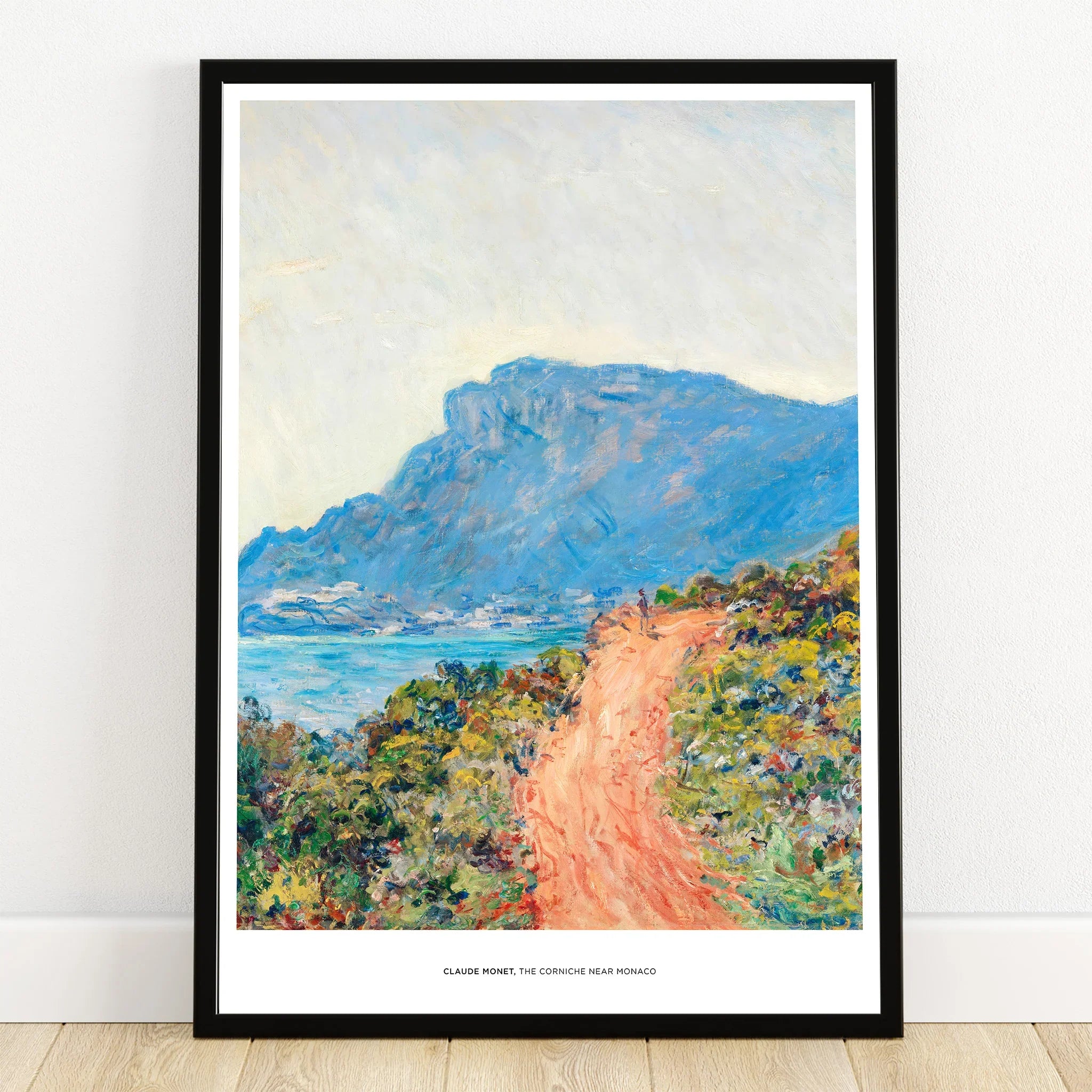 Framed art print of Monet's coastal landscape with blue mountains, sea, and winding path