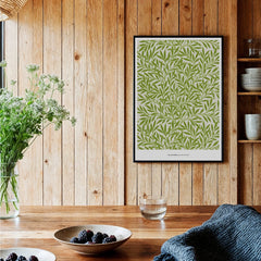 Framed botanical art print with green leaf pattern on wood wall in modern kitchen decor
