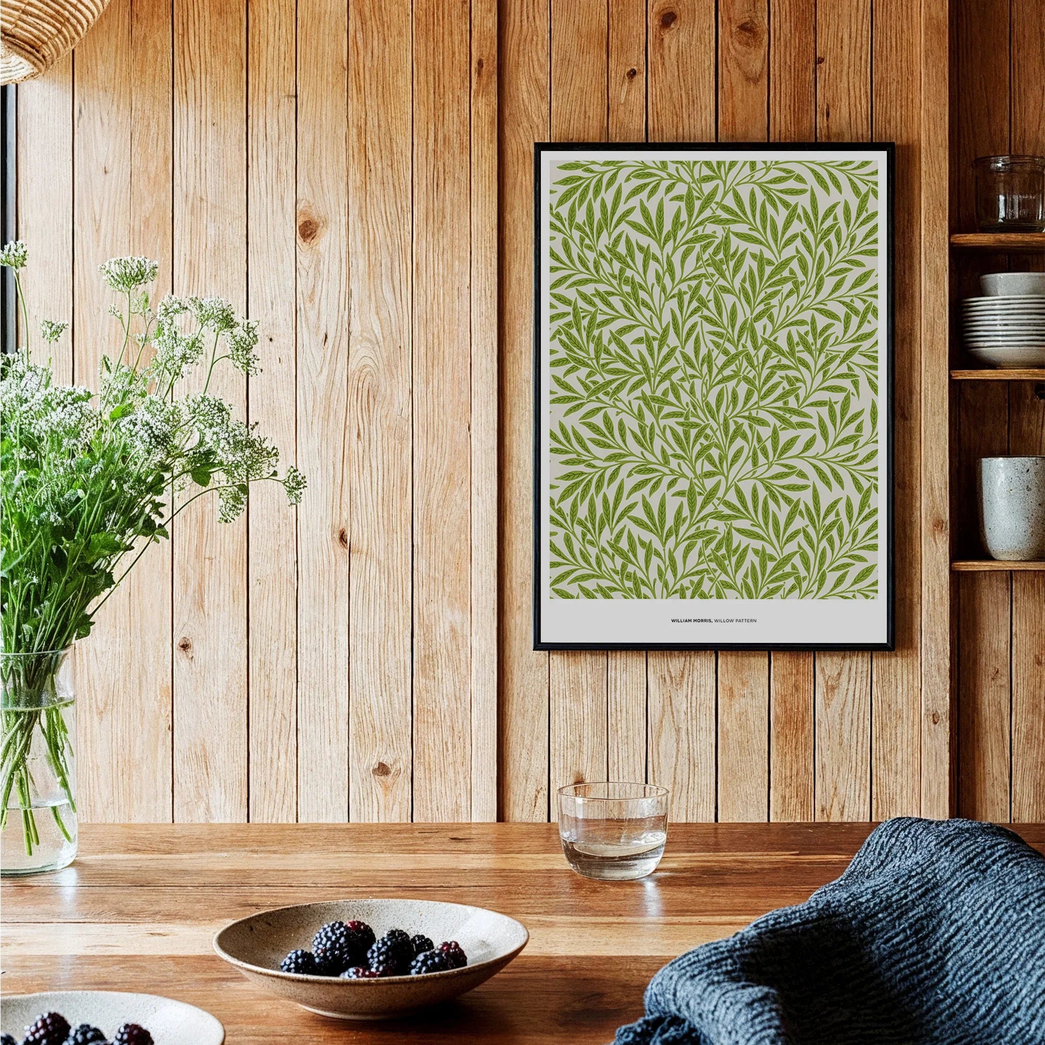 Framed botanical art print with green leaf pattern on wood wall in modern kitchen decor