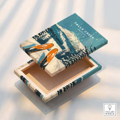A beautifully designed box featuring Falls Creek Wall Art, showcasing a winter scene with skis and mountains.