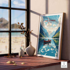 Fjords Wall Art Norway displayed on a wooden table near a window, featuring a serene landscape and a boat on water.