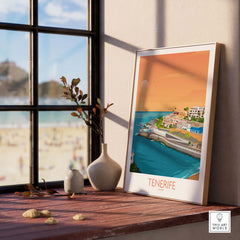 Tenerife wall art print displayed on a windowsill, showcasing colorful coastal landscape and beach view.