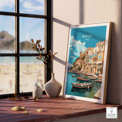 Framed Sicily Wall Art Print displayed on a table, showcasing vibrant colors and Italian coastal scenery.