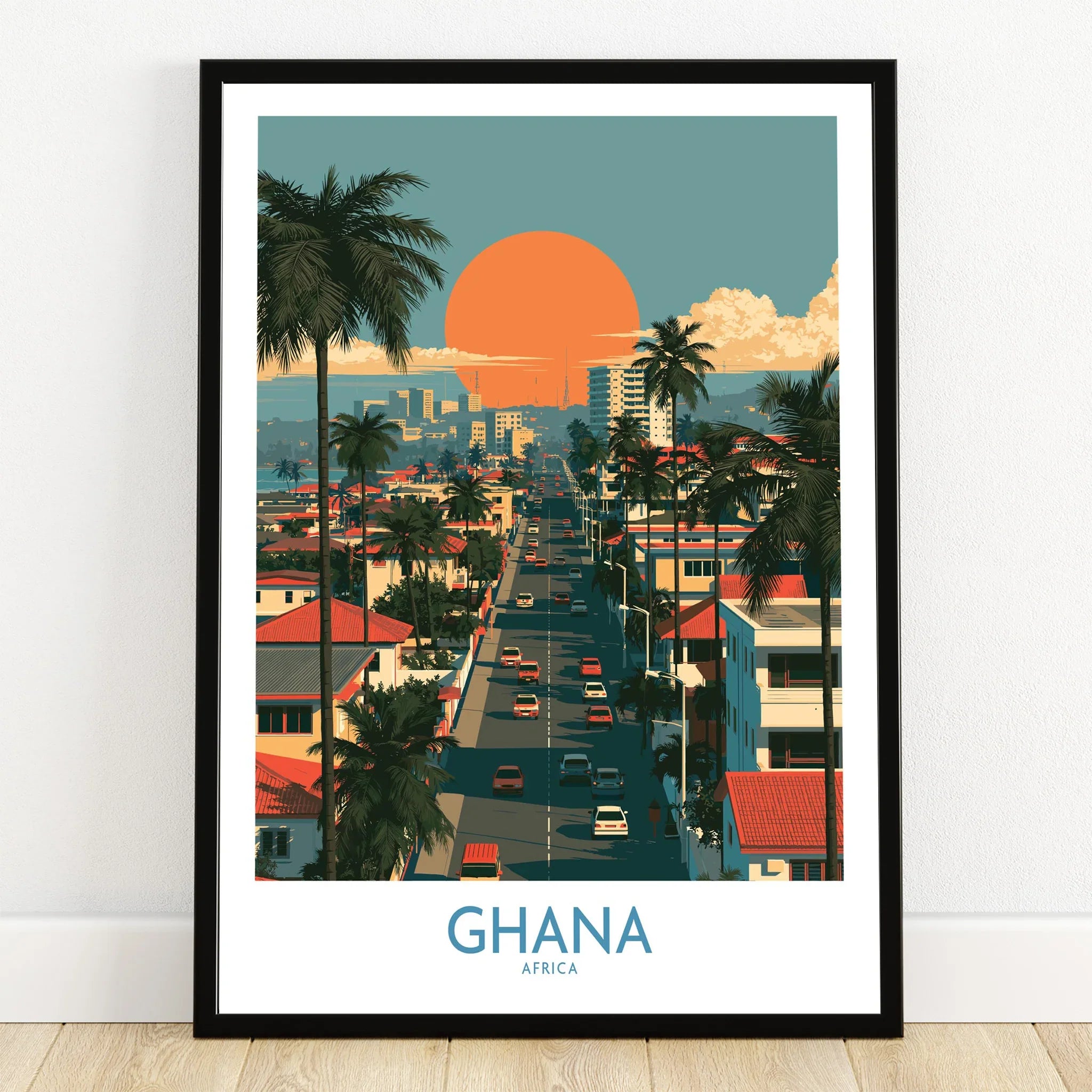 Ghana City Sunset Wall Art — art print in black frame on wooden floor