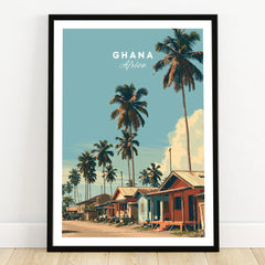 Ghana Coastal Village Travel Poster — art print in black frame on wooden floor