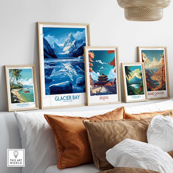 A collection of travel posters on a wall featuring Glacier Bay, Philippines, Beijing, Costa Rica, and the Grand Canyon.