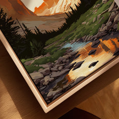 Framed canvas print of a mountain landscape with trees, rocks, and a reflective stream.