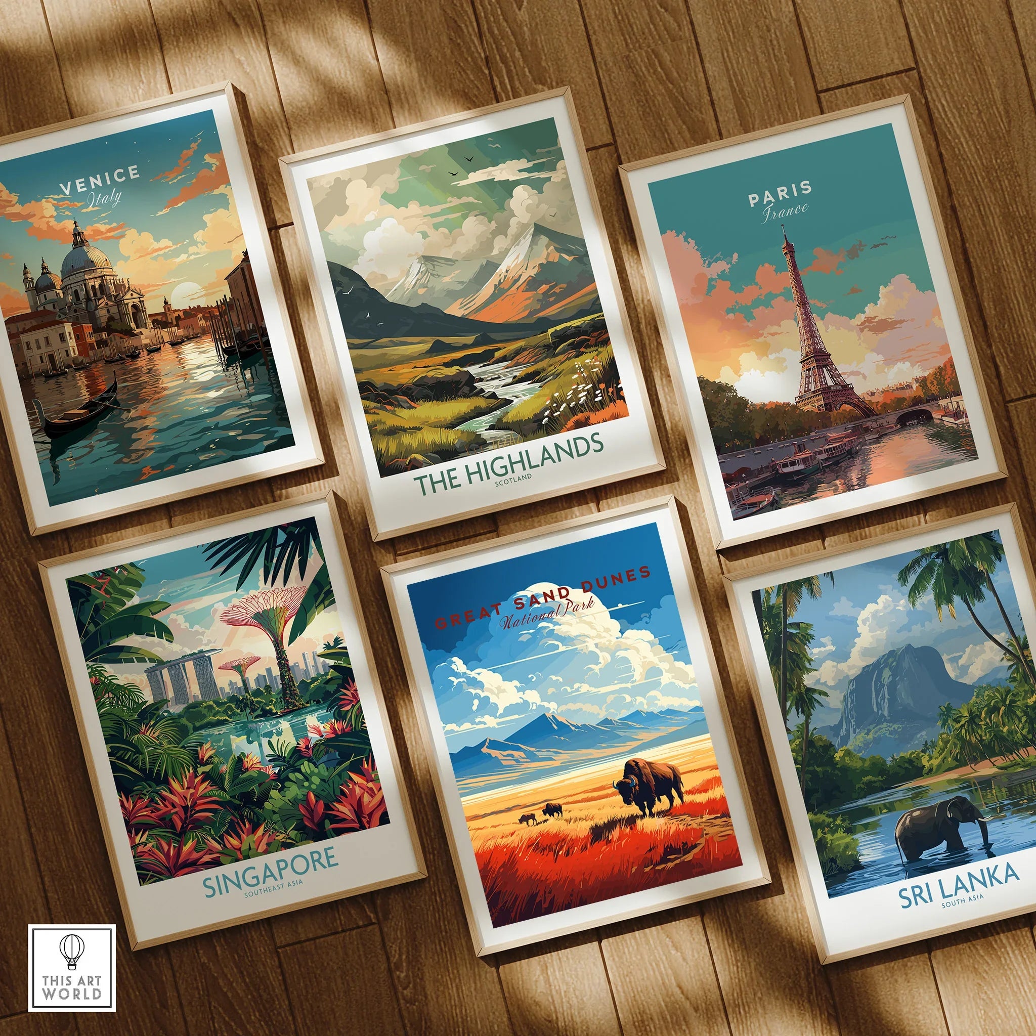 Set of six framed travel posters on wooden floor, featuring Venice, Paris, Singapore, the Highlands, Great Sand Dunes National Park, and Sri Lanka landscapes.