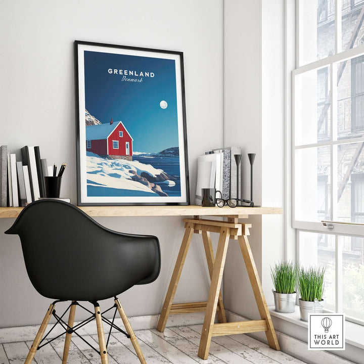 Greenland travel poster featuring a vibrant red house against a snowy landscape, displayed in a modern home office.