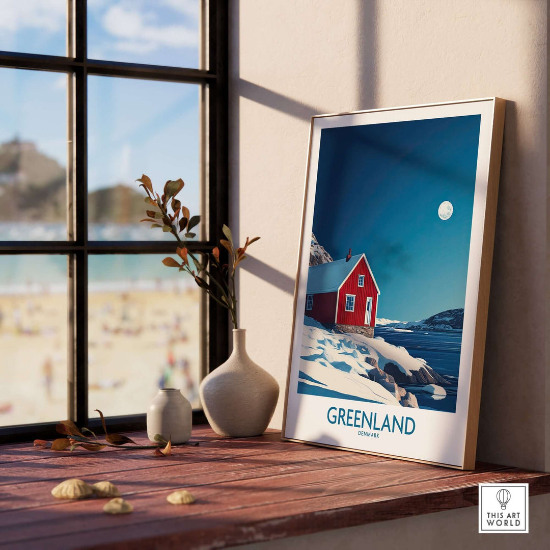 Framed Greenland wall art featuring a red house and scenic landscape, enhancing home decor with a travel theme.