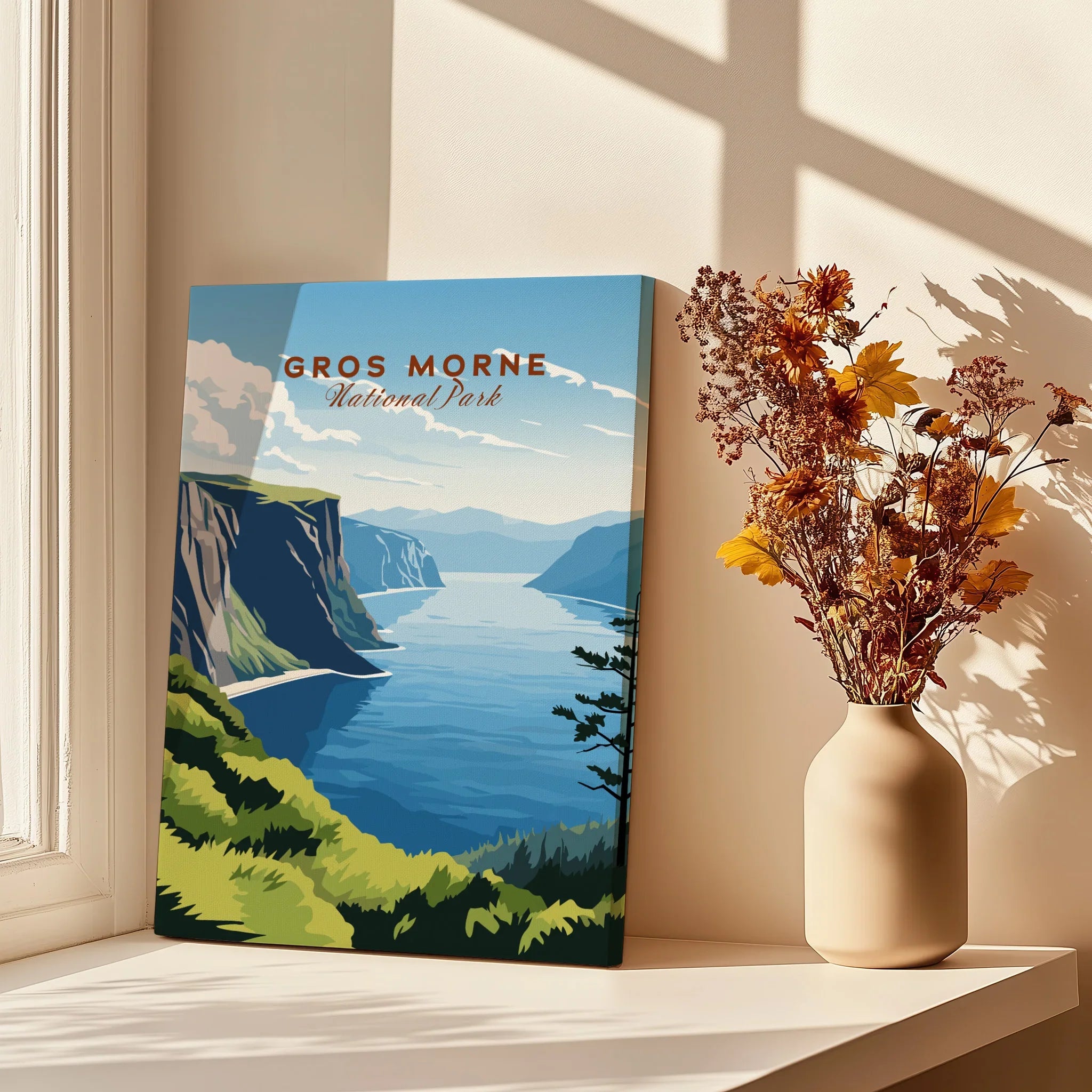 Gros Morne National Park print with scenic cliffs and water, styled by a window with flowers.