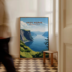 Gros Morne National Park travel poster framed on floor in a bright hallway, man walking by