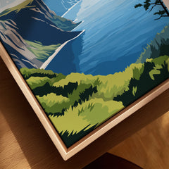 Closeup of a framed canvas print featuring a colorful landscape with mountains and water.