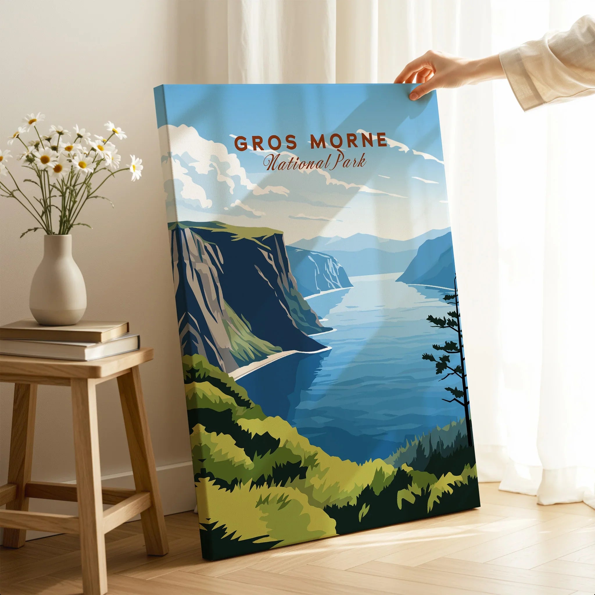 Hand holding Gros Morne National Park travel poster canvas in modern home decor setting