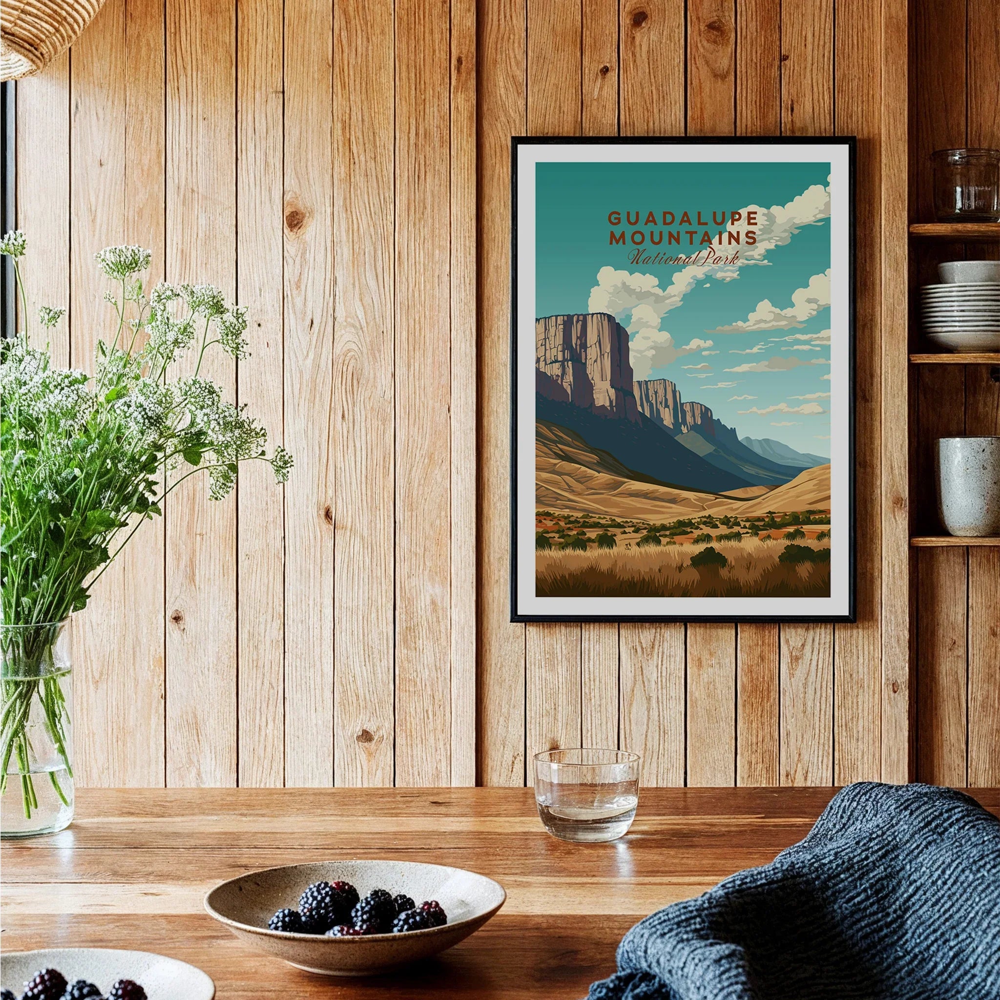 Guadalupe Mountains National Park art print in black frame hanging in a rustic kitchen setting.