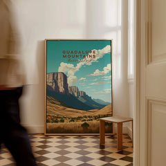 Guadalupe Mountains National Park travel poster framed on floor, man walking past in home interior