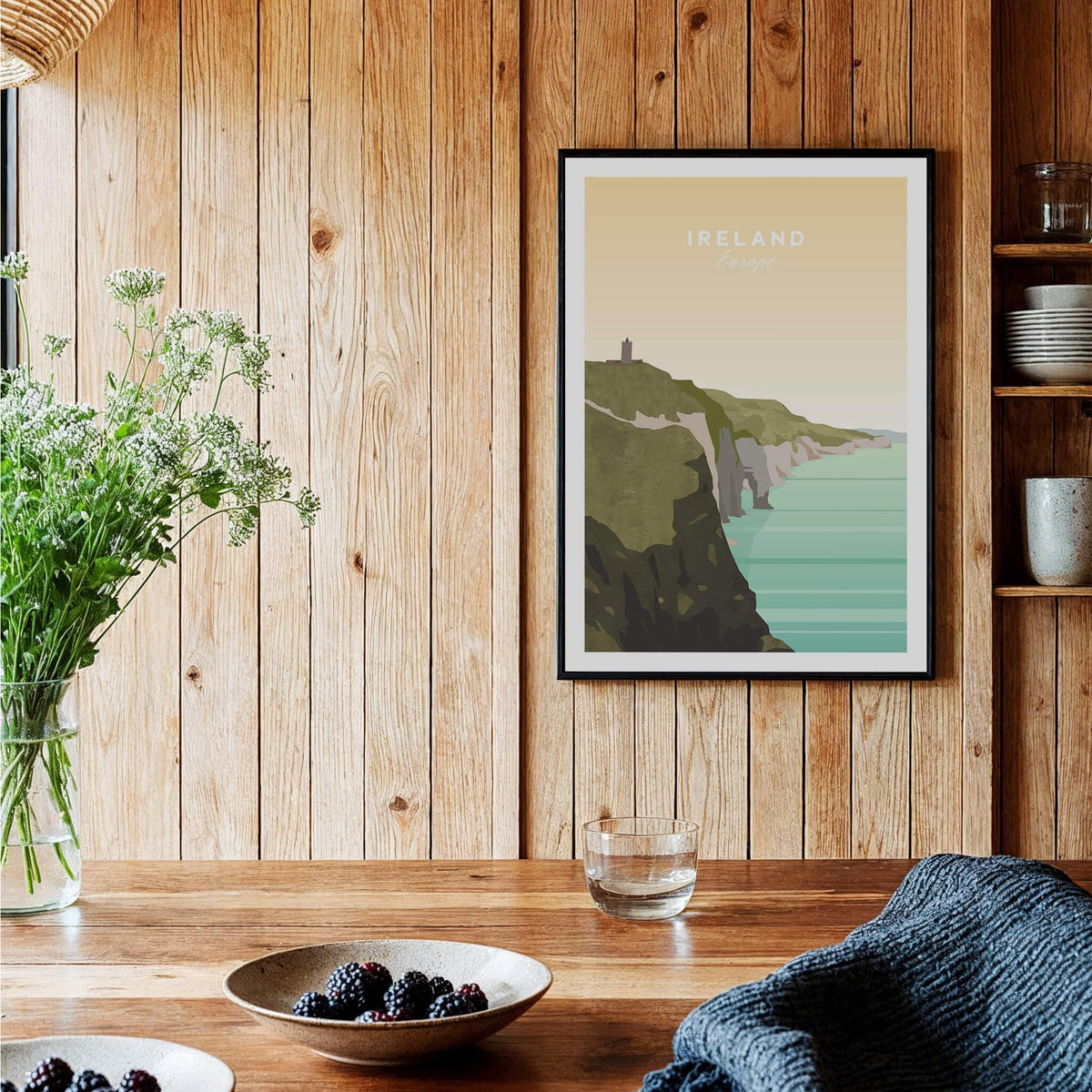 Ireland travel poster wall art featuring cliffs and ocean in a modern wood dining room