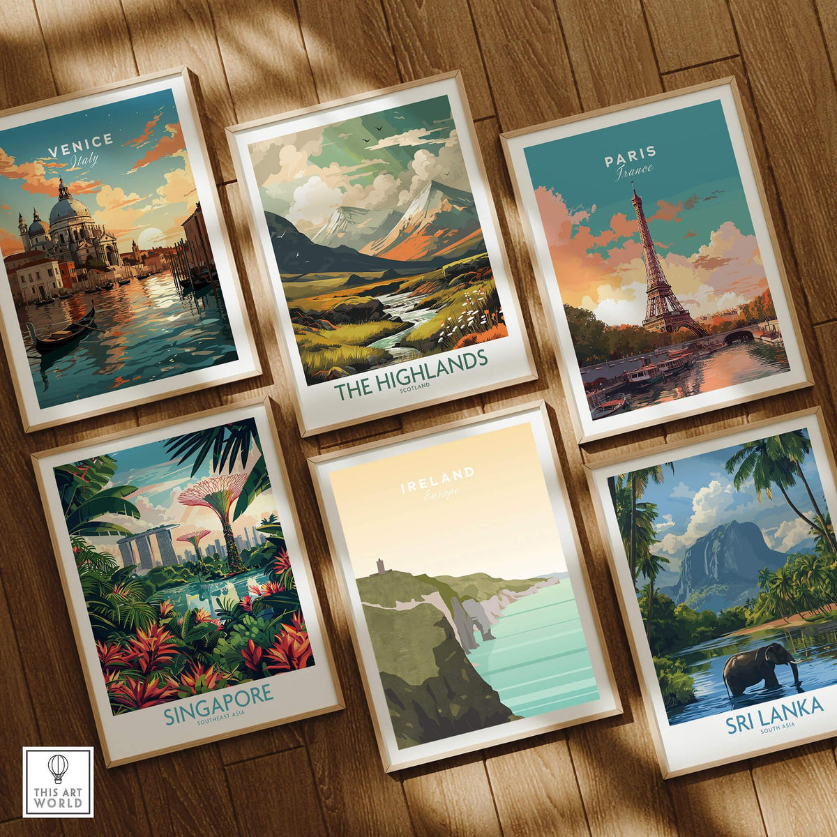 Framed travel posters featuring Venice, Paris, Highlands, Singapore, Ireland, and Sri Lanka wall art on a wooden floor