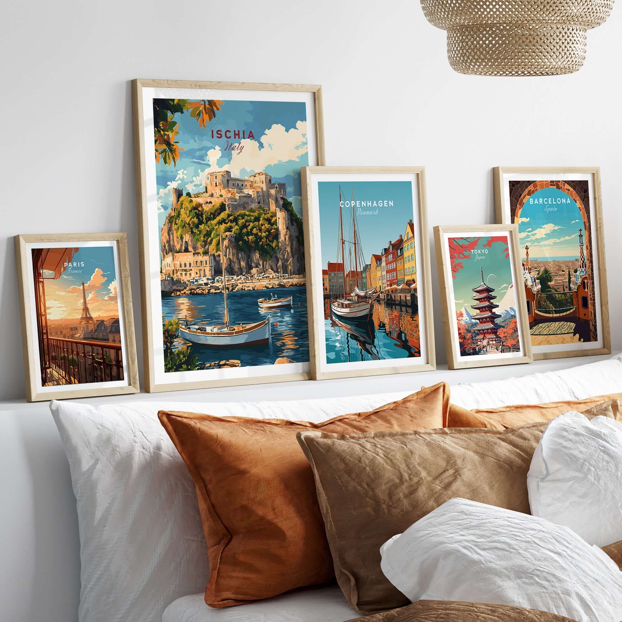 Ischia Travel Print Italy displayed among travel prints on a cozy couch, showcasing beautiful art from various destinations.