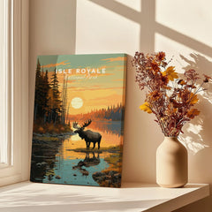 Isle Royale National Park poster with moose at sunset, canvas print on windowsill beside vase of dried flowers