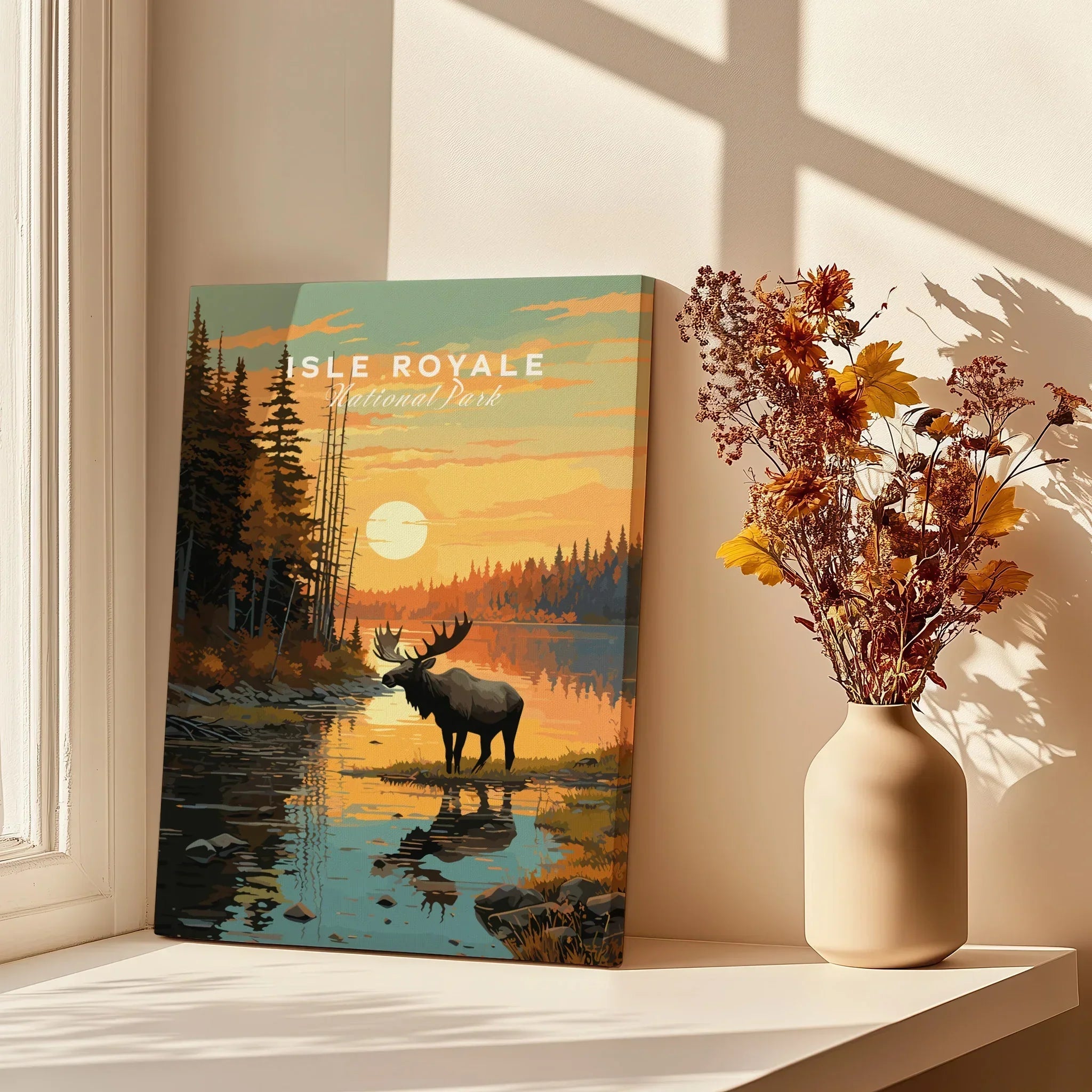 Isle Royale National Park poster with moose at sunset, canvas print on windowsill beside vase of dried flowers