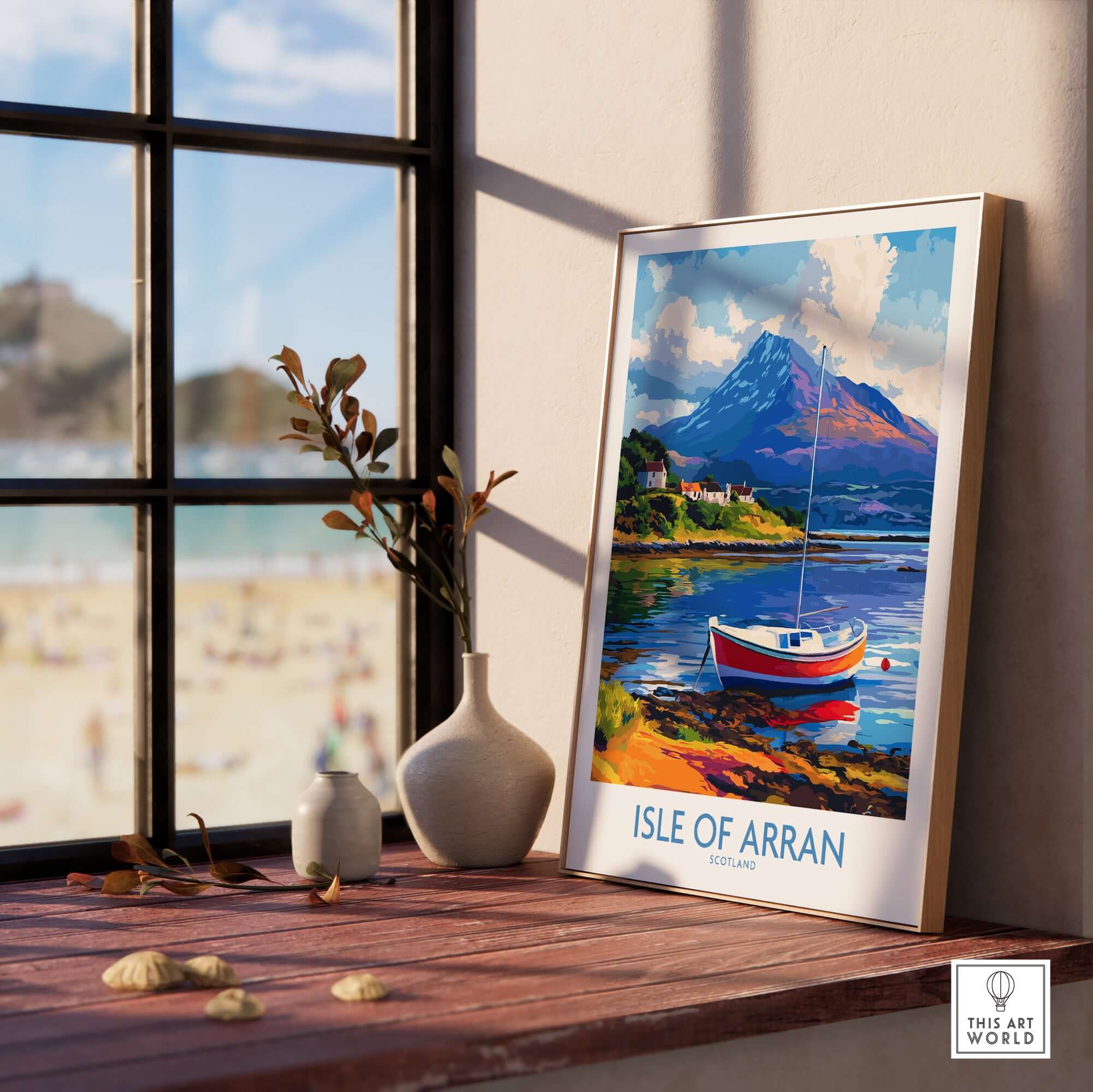 Isle of Arran Poster Scotland displayed on a wooden table with scenic beach view and boat imagery.