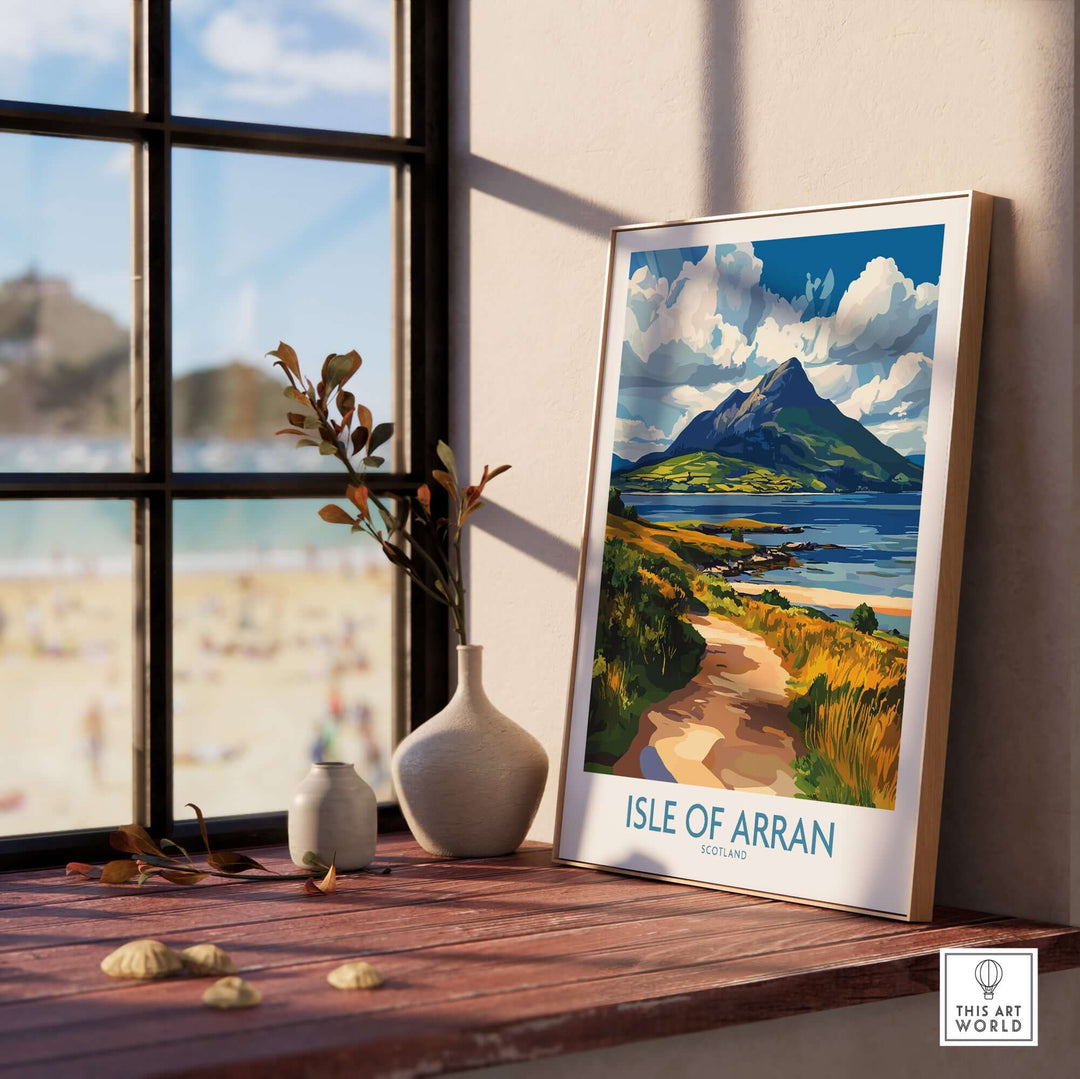 Isle of Arran poster displayed by a window, showcasing the scenic beauty of the Scottish island in vibrant colors.