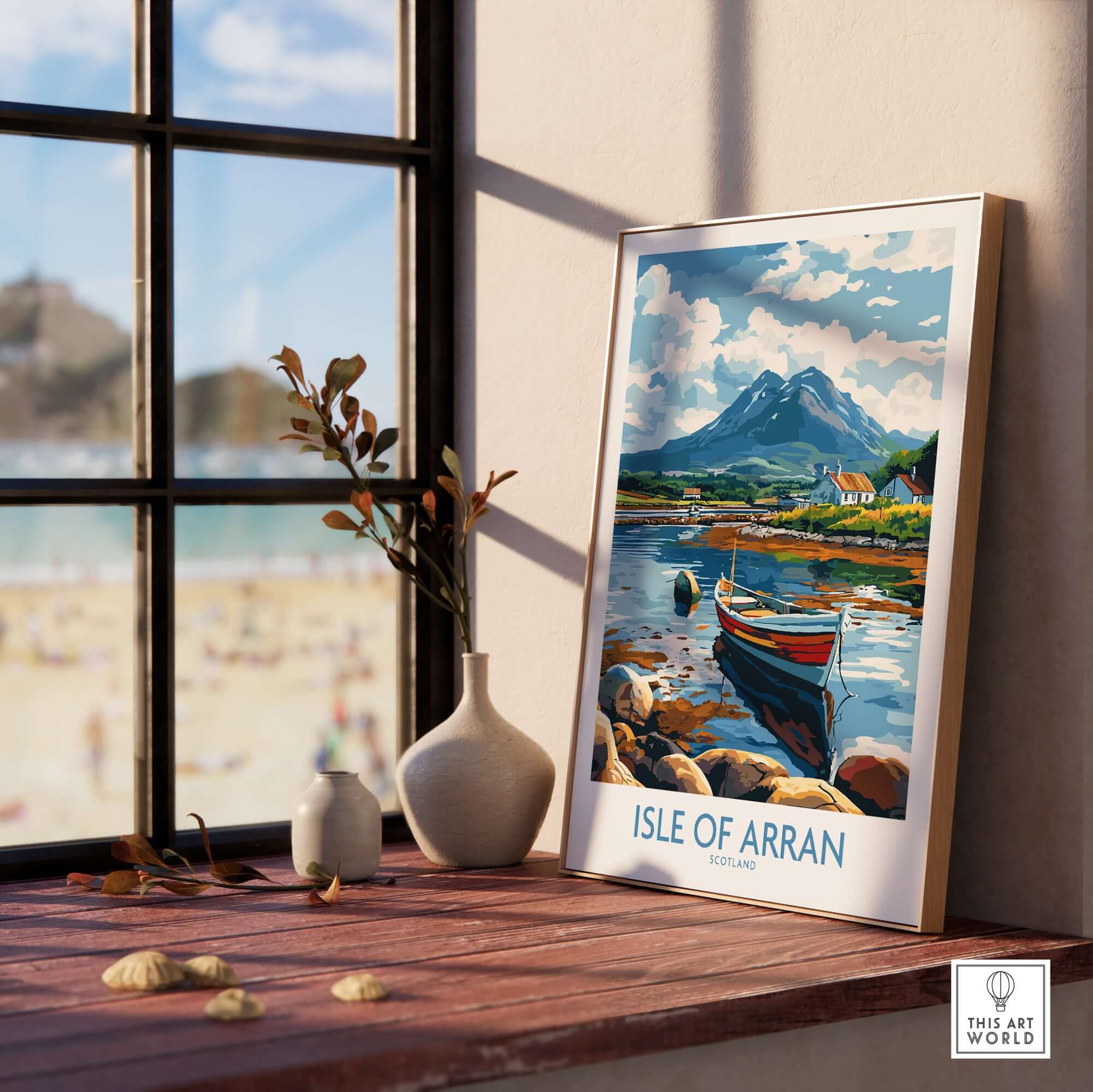 Isle of Arran Scotland Travel Poster displayed on a table with a scenic view of mountains and a boat.
