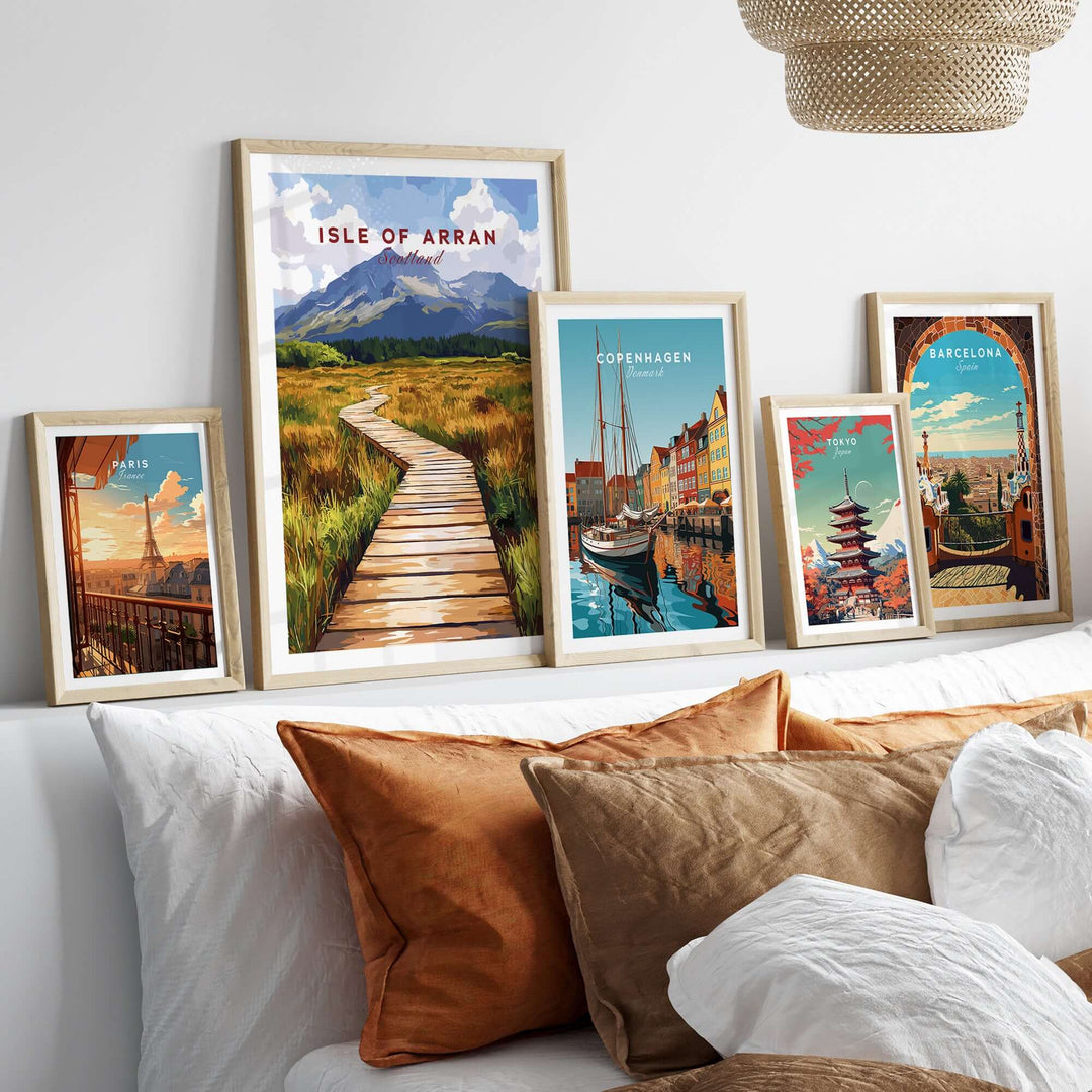 Isle of Arran wall art displayed amid other cityscape prints, enhancing a cozy living room decor.