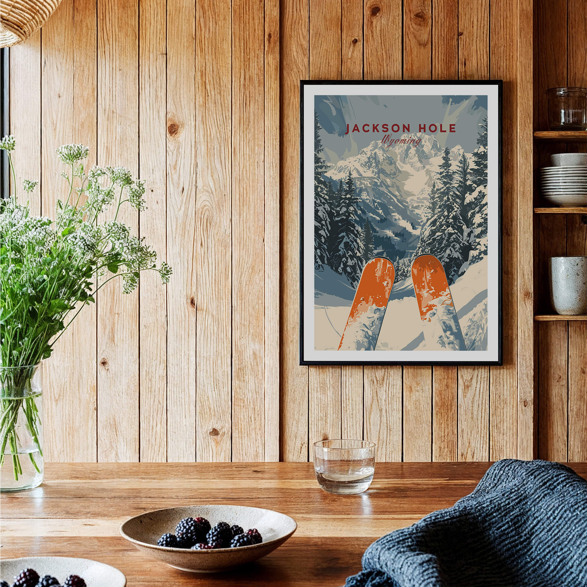 Jackson Hole Travel Poster - Wyoming framed on a wooden wall with scenic snowy mountain backdrop and ski poles.