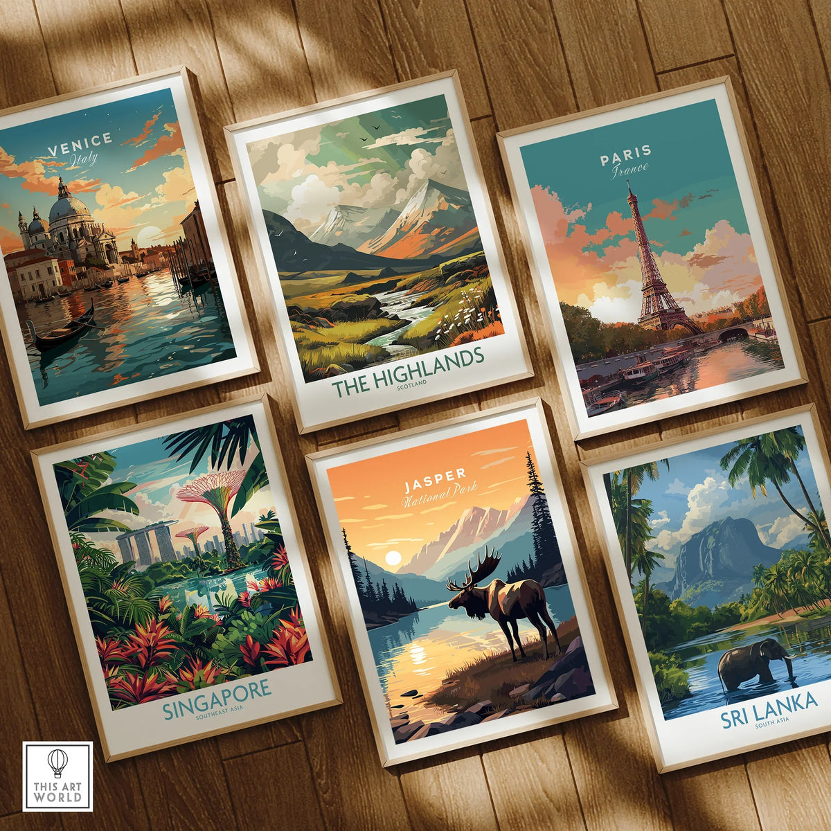 Set of six framed travel posters featuring Venice, the Highlands, Paris, Singapore, Jasper National Park, and Sri Lanka on a wooden floor.