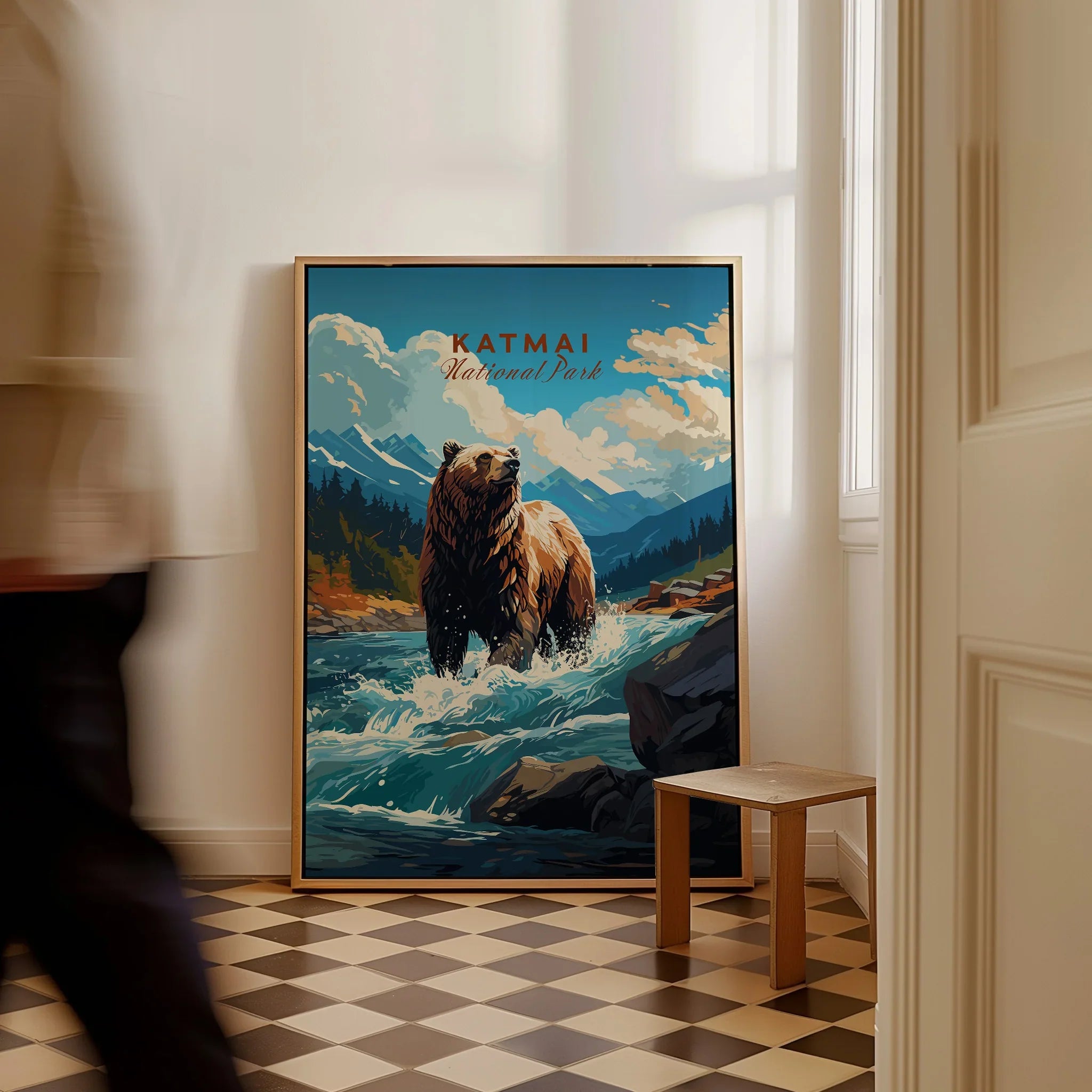 Framed Katmai National Park poster with a bear in a river, leaning on floor in a bright room