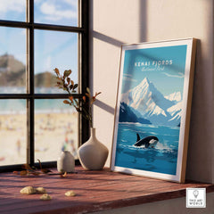 Kenai Fjords poster featuring a killer whale, framed and displayed by a window, capturing nature's beauty and adventure.